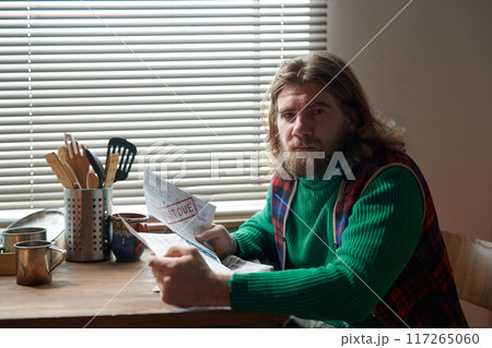 Reading Morning Newspaper Near Kitchen Window 117265060