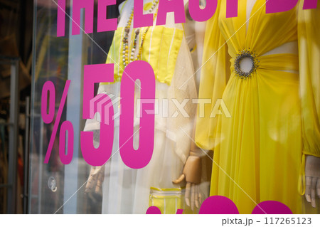 Large Sale text letters on red background on clothing store . 117265123