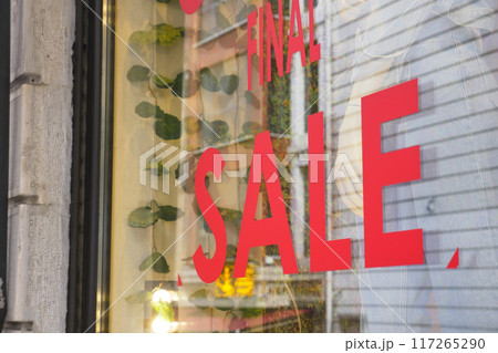 Large Sale text letters on red background on clothing store . Large Sale text letters on red background on clothing store . 117265290
