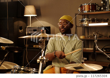 Playing Drums in Music Studio with Serious Expression 117265304