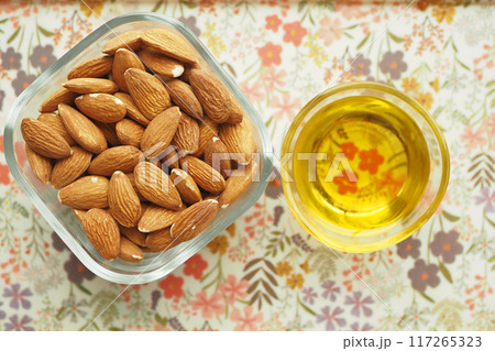 almond oils and fresh nuts on table almond oils and fresh nuts on table 117265323
