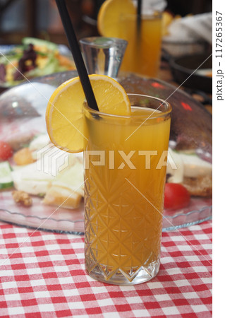 A Refreshing Citrus Drink with an Attractive Garnish Served on a Charming Picnic Table A Refreshing Citrus Drink with an Attractive Garnish Served on a Charming Picnic Table 117265367