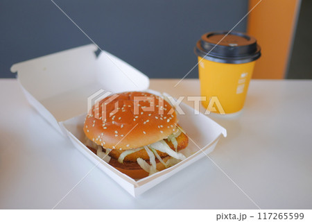 Enjoying a Delicious Burger and Coffee Presented Beautifully on a Minimalist Table Setting 117265599