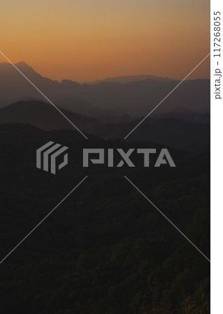 nature traveling with orange sky and layer of mountain with sunrise background 117268055