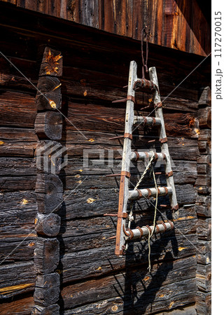 Decoration. Vintage things. A wooden harrow on wall of old wooden house. 117270015