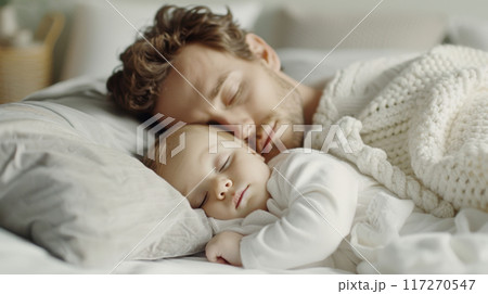 Caucasian couple father and baby are sleeping on bed with grey pillows and soft fabric blankets in modern white bedroom together Caucasian couple father and baby are sleeping on bed with grey pillows and soft fabric blankets in modern white bedroom together 117270547