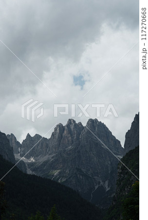 Rocky peaks of the Italian Dolomites surrounded by clouds before a storm. 117270668
