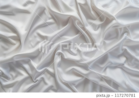 Close-up view of white fabric with subtle texture, folded and creased. Fabric curled edges add depth. Blurred background highlights fabric details. Soft atmosphere created by white. 117270781