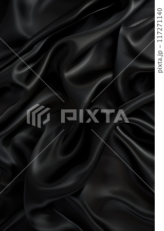 Close-up view of black fabric with slight sheen, possibly silk satin. Fabric folded in half reveals intricate texture, layers. Blurred background highlights fabric. Black and gray add depth, contrast. Close-up view of black fabric with slight sheen, possibly silk satin. Fabric folded in half reveals intricate texture, layers. Blurred background highlights fabric. Black and gray add depth, contrast. 117271140