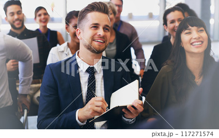 Please repeat that so I can make a note. Cropped shot of a handsome young businessman sitting with his colleagues and holding a notebook while in the office. Please repeat that so I can make a note. Cropped shot of a handsome young businessman sitting with his colleagues and holding a notebook while in the office. 117271574