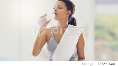 Staying hydrated. Cropped portrait of an attractive young woman taking a water break during her workout at home. 117271588