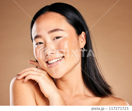 Portrait, beauty and treatment with a model asian woman in studio on a beige background for natural skincare. Wellness, aesthetic or facial with an attractive young female posing to promote antiaging Portrait, beauty and treatment with a model asian woman in studio on a beige background for natural skincare. Wellness, aesthetic or facial with an attractive young female posing to promote antiaging 117271725