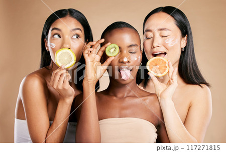 Diversity, women and fruit for natural beauty, dermatology and healthy lifestyle with girls on brown studio background. Cosmetics, friends or ladies with vitamin c, skincare and confidence or luxury Diversity, women and fruit for natural beauty, dermatology and healthy lifestyle with girls on brown studio background. Cosmetics, friends or ladies with vitamin c, skincare and confidence or luxury 117271815