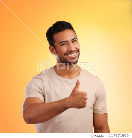 Hands, thumbs up and portrait of man in studio isolated on a yellow background. Face, fashion and happy male model with hand gesture for like emoji, motivation or success, agreement or thank you. 117271906