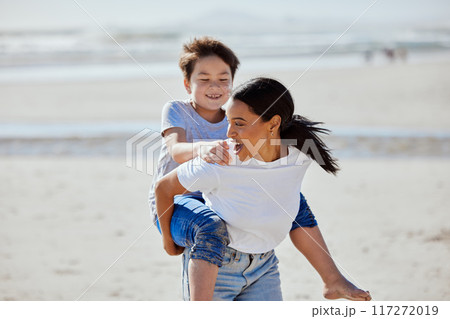 Mother, beach piggyback and asian child with smile, family bonding and outdoor vacation in sunshine. Happy family, interracial and ride on woman back for adoption, love and game by ocean for holiday Mother, beach piggyback and asian child with smile, family bonding and outdoor vacation in sunshine. Happy family, interracial and ride on woman back for adoption, love and game by ocean for holiday 117272019