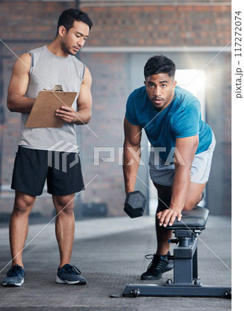 Personal trainer, fitness and coach building muscle for health, cardio and wellness in gym. Athlete men, bodybuilder coaching and healthy lifestyle motivation or sports training workout with dumbbell 117272074