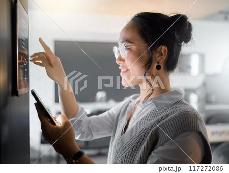 Smart home wall system, phone and woman with digital monitor for house automation, air conditioning or safety security network. App software, ui dashboard panel and Asian girl programming IOT tech Smart home wall system, phone and woman with digital monitor for house automation, air conditioning or safety security network. App software, ui dashboard panel and Asian girl programming IOT tech 117272086