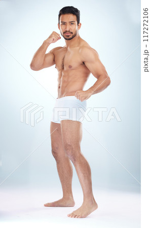 Fitness, underwear body and man with fist, studio or martial arts for muscle, wellness or strong by backdrop. Model, mma and shirtless for balance, posture or portrait by studio background with focus Fitness, underwear body and man with fist, studio or martial arts for muscle, wellness or strong by backdrop. Model, mma and shirtless for balance, posture or portrait by studio background with focus 117272106