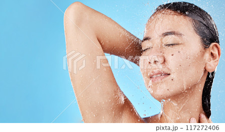 Woman, face and shower for skincare hydration, hygiene or beauty against a blue studio background. Female smile in relax for fresh clean water wash in body care or healthy moisture for skin on mockup 117272406