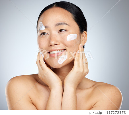Woman with sunscreen on face in studio, skincare cream product for natural uv protection and cosmetic wellness. Spa advertising beauty facial, happy korean girl with smile and dermatology spf lotion 117272578