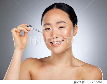Woman beauty, facial serum and essential oil portrait, aesthetic makeup and glowing skincare on studio background in Tokyo. Japanese model face, liquid cosmetic product and hyaluronic acid wellness 117272615
