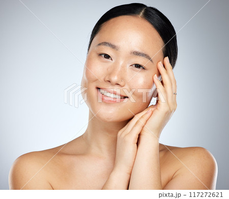 Face, beauty skicare and asian woman with makeup, cosmetics and skin health or wellness . Portrait healthy girl smile in studio against a grey background and routine for soft, smooth or glowing skin Face, beauty skicare and asian woman with makeup, cosmetics and skin health or wellness . Portrait healthy girl smile in studio against a grey background and routine for soft, smooth or glowing skin 117272621