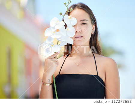 Beauty, flower and portrait of girl in city standing in urban road, orchid in hand. Fashion, cosmetics and creative shot of young Asian woman with natural beauty enjoying summer, weekend and holiday 117272682