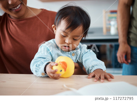 Sleeping, disability and baby with down syndrome after playing with toy asleep on his mothers lap in family home. Mama, exhausted and tired child with special needs in development with lovely parents Sleeping, disability and baby with down syndrome after playing with toy asleep on his mothers lap in family home. Mama, exhausted and tired child with special needs in development with lovely parents 117272795