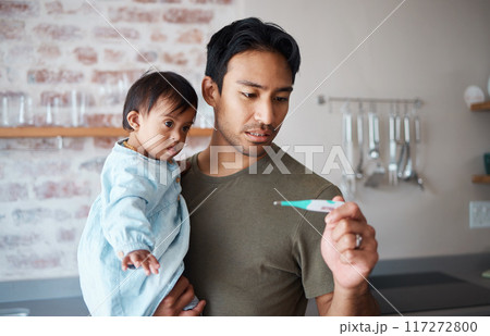 Down syndrome, thermometer and parent worried about baby health, checking fever and temperature in a kitchen. Love, disability and child care with special needs newborn bonding with concerned father 117272800