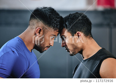 Healthy, serious and fit male athletes staring, facing and looking ready before a fight. Strong young men in an active challenge, a battle of power against strength and a motivation for winning. Healthy, serious and fit male athletes staring, facing and looking ready before a fight. Strong young men in an active challenge, a battle of power against strength and a motivation for winning. 117272916