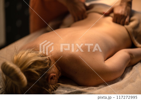 Back massage. Masseuse caring for clients. Massage for body health Back massage. Masseuse caring for clients. Massage for body health 117272995