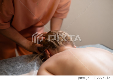 Head massage. Masseuse, client and scalp care, headache treatment and physiotherapy for healing Head massage. Masseuse, client and scalp care, headache treatment and physiotherapy for healing 117273012