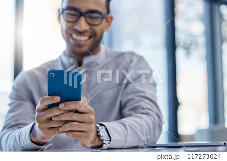 Phone with good news for a happy and excited male entrepreneur reading online social media posts in the office. Business man texting and browsing the internet or using mobile app, web or website 117273024