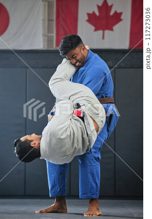 Mma, training and fighting with a student and teacher exercising during a self defense workout in a gym or fight studio. Combat sport with a fighter and his opponent in gi or uniform in a match 117273036