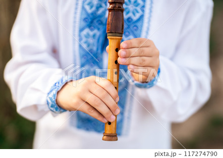 Hands Of Little Boy Kid Playing On Woodwind Wooden Flute - Ukrainian Sopilka 117274790