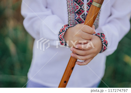 Hands Of Little Boy Kid Playing On Woodwind Wooden Flute - Ukrainian Sopilka Hands Of Little Boy Kid Playing On Woodwind Wooden Flute - Ukrainian Sopilka 117274797