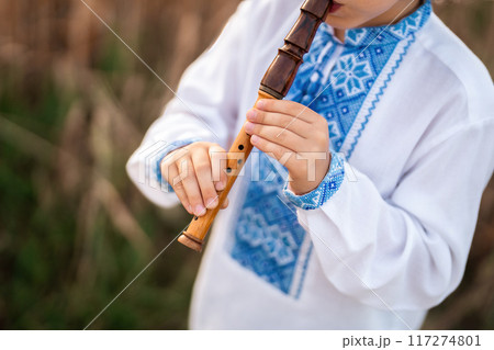 Hands Of Little Boy Kid Playing On Woodwind Wooden Flute - Ukrainian Sopilka 117274801