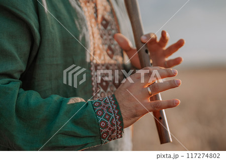 Hands Of Man Playing On Woodwind Wooden Flute - Ukrainian Sopilka Hands Of Man Playing On Woodwind Wooden Flute - Ukrainian Sopilka 117274802