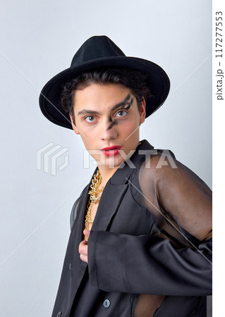 androgynous american gay man with make up in black fashionable outfit posing androgynous american gay man with make up in black fashionable outfit posing 117277553