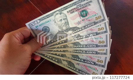 Hand Holding 50 US Dollar Bills. 117277724