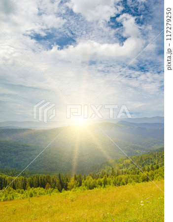 Picturesque mountain landscape with mountain ranges, coniferous forests and sunrise. 117279250