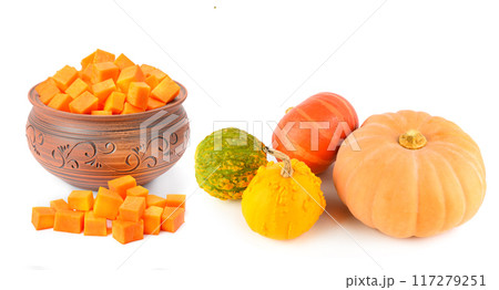 Whole pumpkins and pieces of peeled pumpkin isolated on white. Free space for text. Wide photo. Collage. 117279251