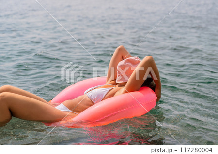 Freelance close up woman hands writing on computer. Well looking middle aged woman typing on laptop keyboard outdoors with beautiful sea view. Freelance close up woman hands writing on computer. Well looking middle aged woman typing on laptop keyboard outdoors with beautiful sea view. 117280004