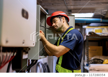 Electrical engineer man checking Power Distribution Cabinet in the control room 117280354