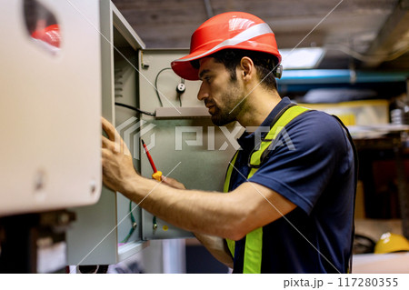 Electrical engineer man checking Power Distribution Cabinet in the control room 117280355