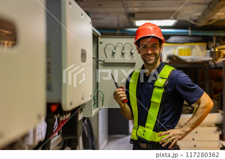 Electrical engineer man checking Power Distribution Cabinet in the control room 117280362