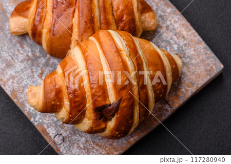 Delicious crispy sweet croissant cornet with chocolate 117280940