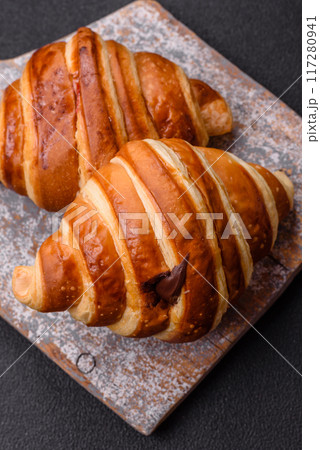 Delicious crispy sweet croissant cornet with chocolate Delicious crispy sweet croissant cornet with chocolate 117280941