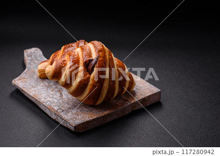 Delicious crispy sweet croissant cornet with chocolate 117280942