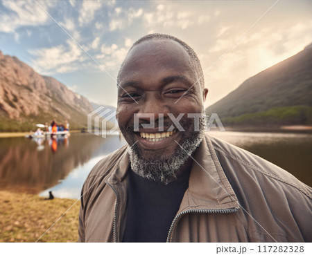 Smiling Man Enjoying Serene Camping Spot 117282328